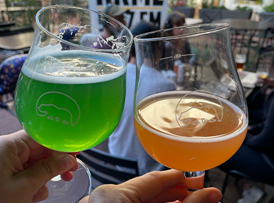 Image of two glasses clanking in a toast with ASB logo